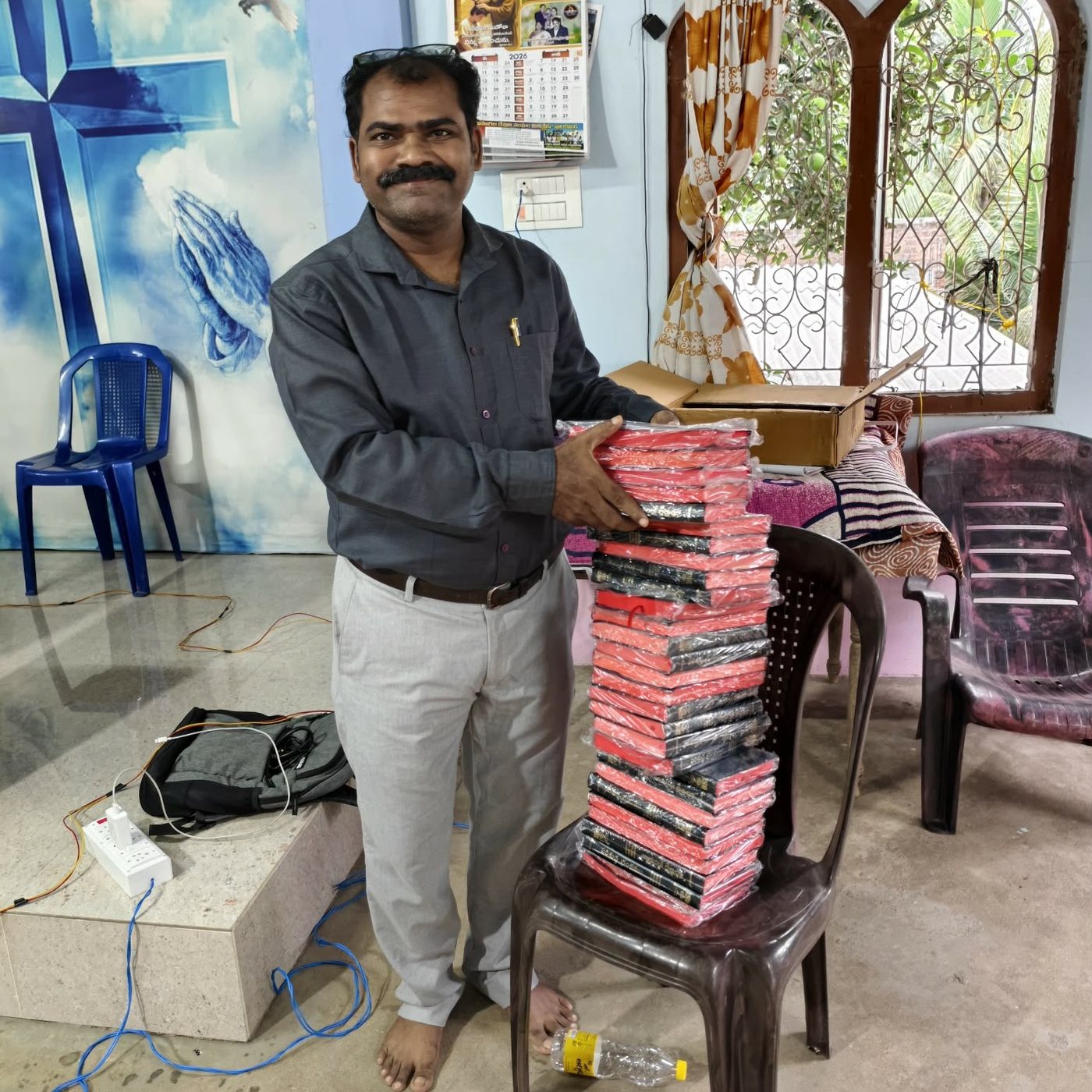 Naveen Kumar Valluri with a stack of books for his students