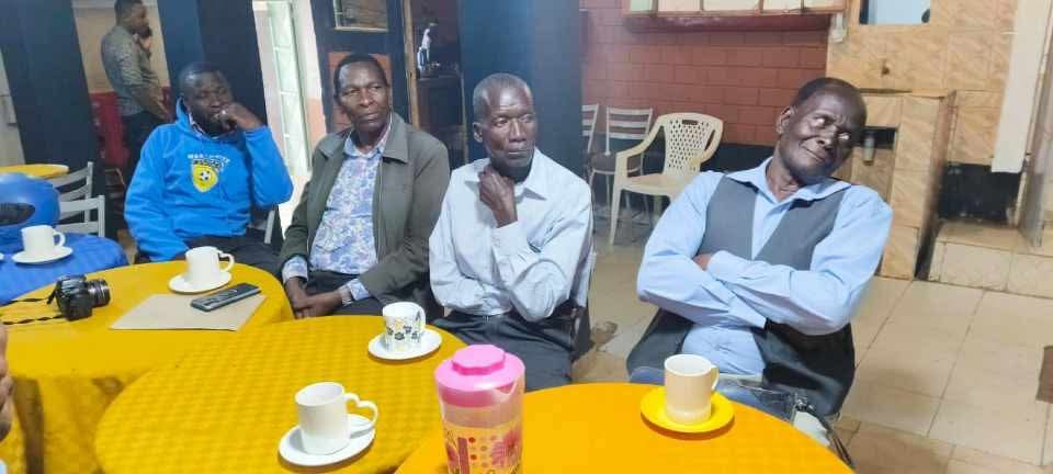 Men in Sebastian Obima's Shepherd School group listening during a class in Kenya